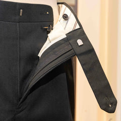 Close-up of the waistband button on the Calsa Nagasaki Trousers Cotton Herringbone Black