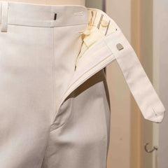 Close-up of the waistband button on the Calsa Nagasaki Trousers Cotton Herringbone Ecru