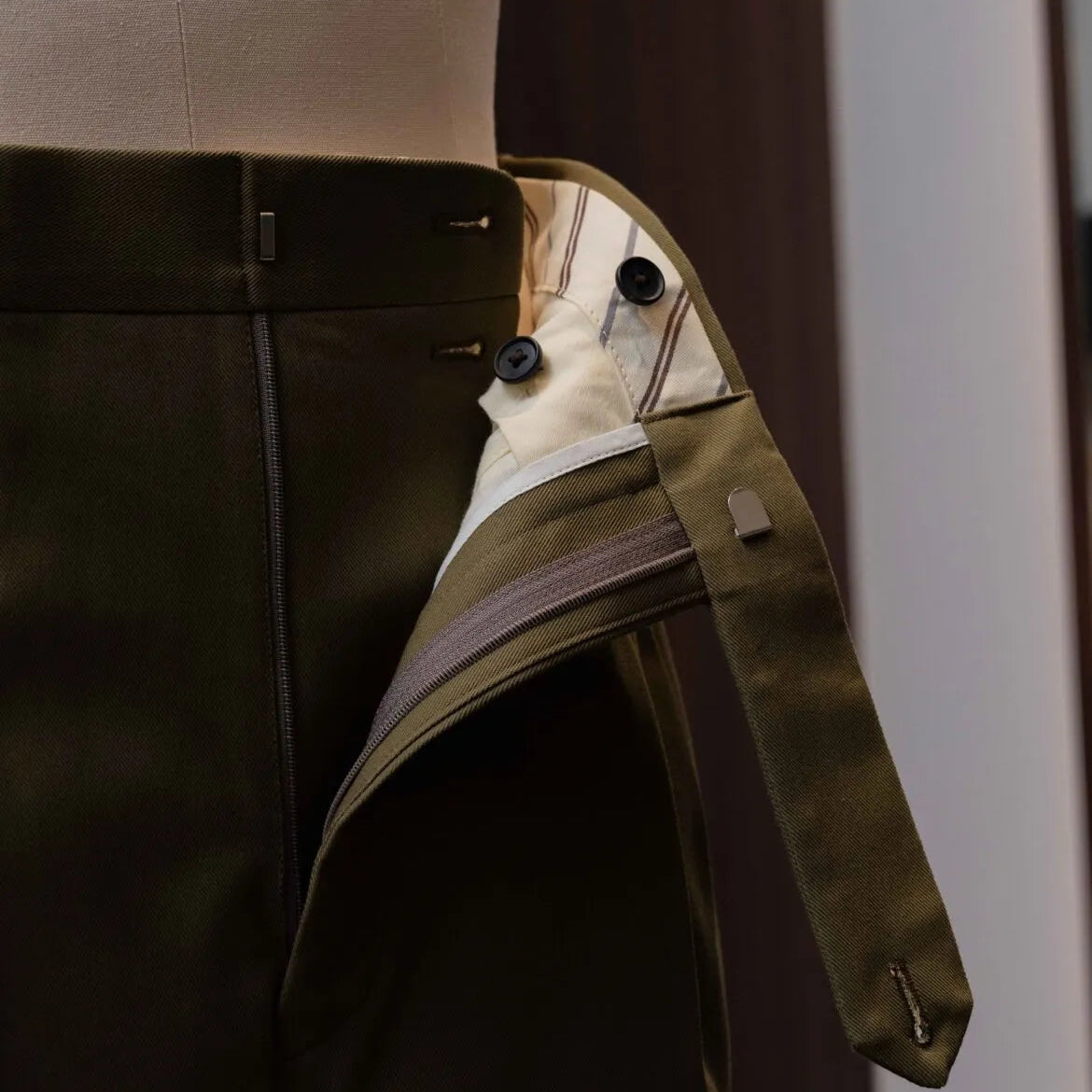 Close-up of the waistband button on the Calsa Nagasaki Trousers Cotton Olive