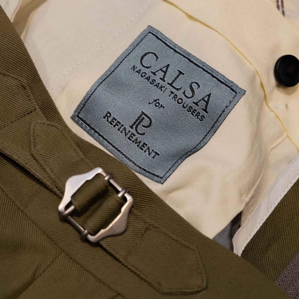 Brand label detail of the Calsa Nagasaki Trousers Cotton Olive