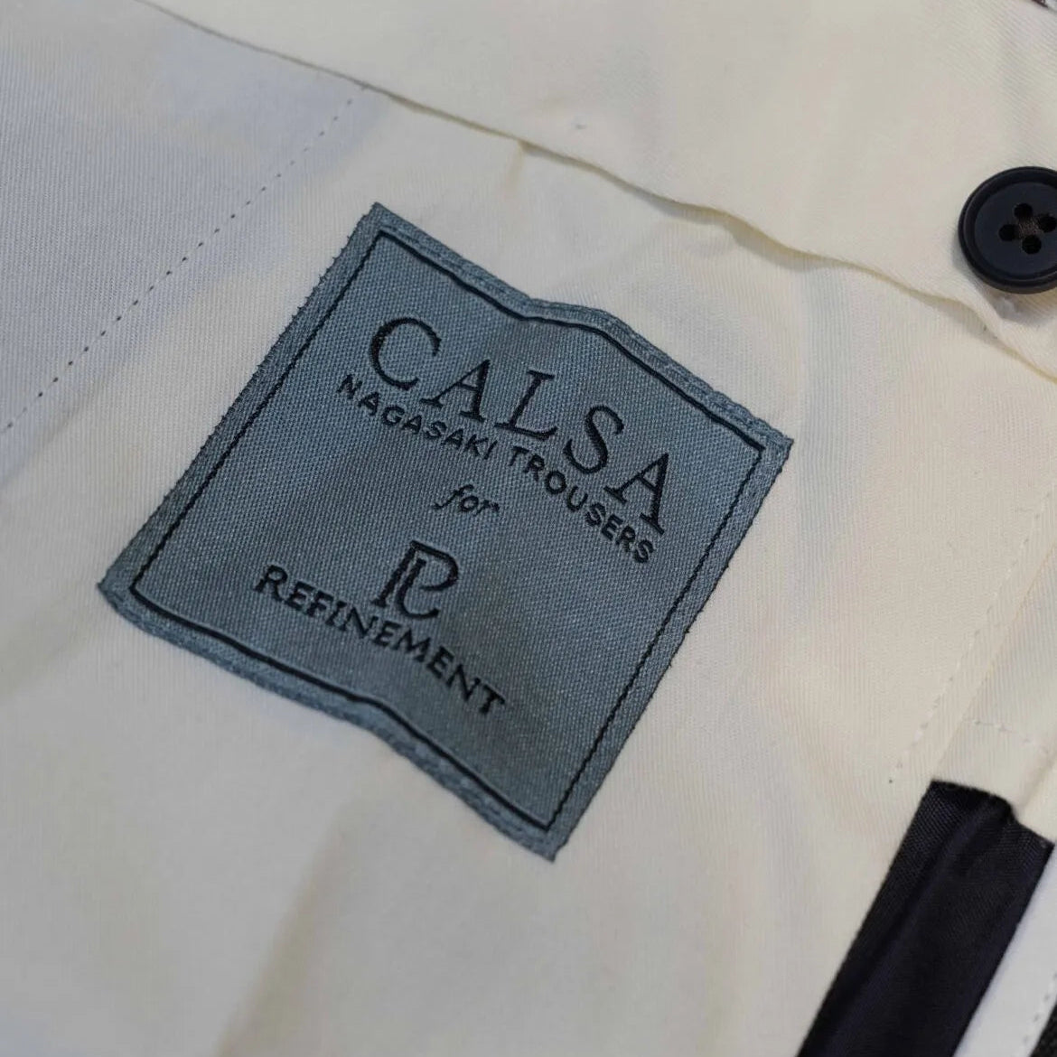 Brand label detail of the Calsa Nagasaki Trousers Covert Dark Green
