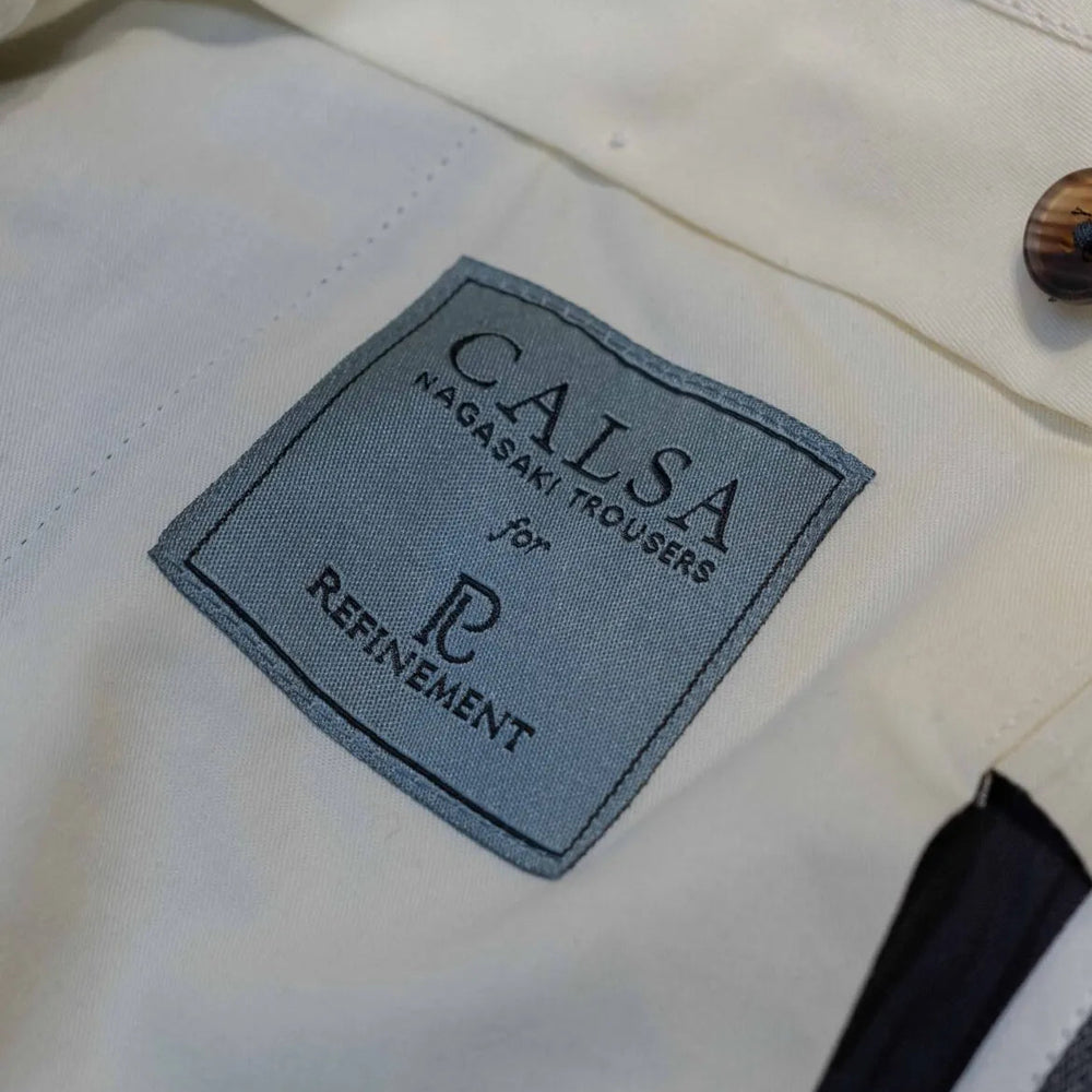 Brand label detail of the Calsa Nagasaki Trousers Covert Grey