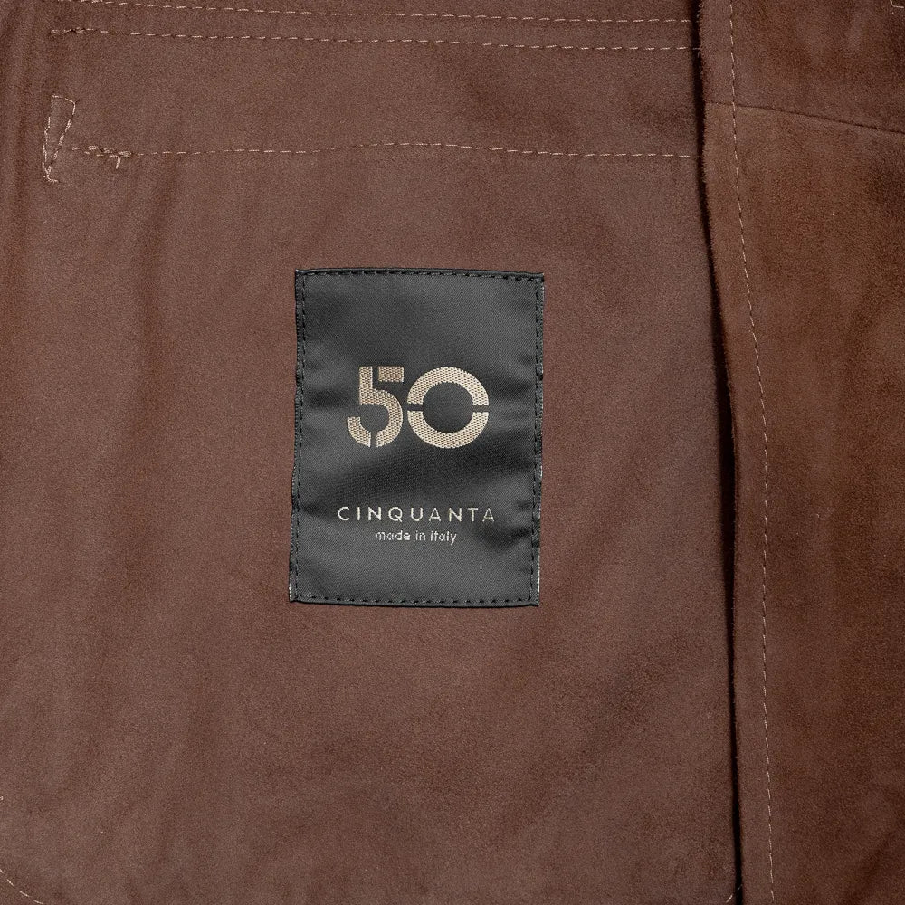 Close-up of the interior label of the Cinquanta Driving Blouson Castagna showing branding and inner lining craftsmanship.
