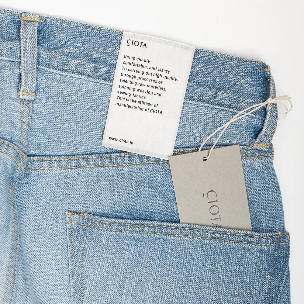 Close-up of the front pocket and coin pocket highlighting stitching and worn-in texture.