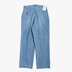 Back view of the Ciota Denim Slacks highlighting the rear pockets, yoke shaping, and denim fading details.