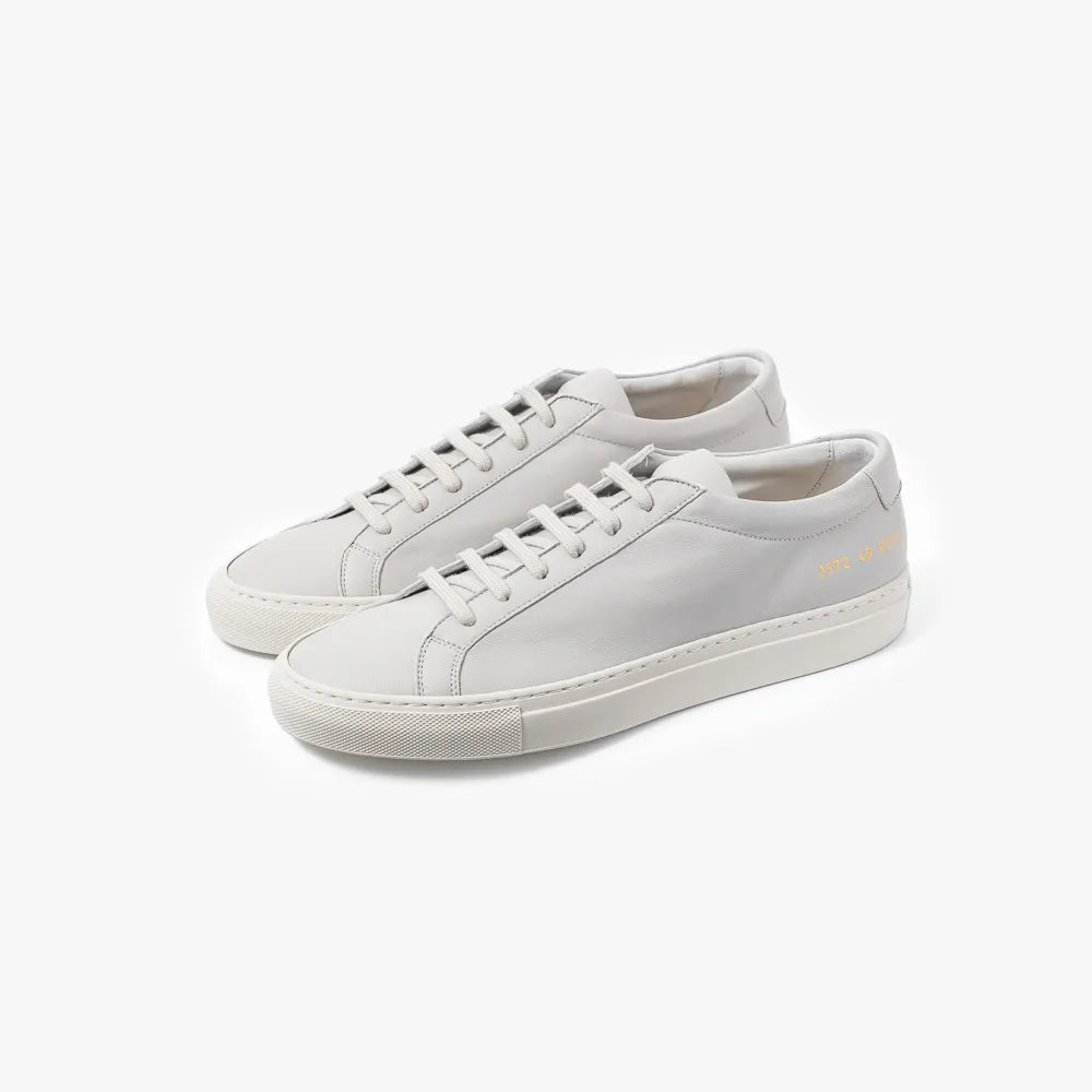 Full view of the Common Projects Achilles Premium 2572 in light grey showing the minimalist low-top silhouette and clean design.