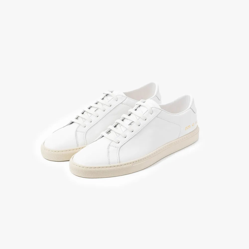 Full view of the Common Projects Achilles Premium 2572 in off white showing the minimalist low-top silhouette and clean design.