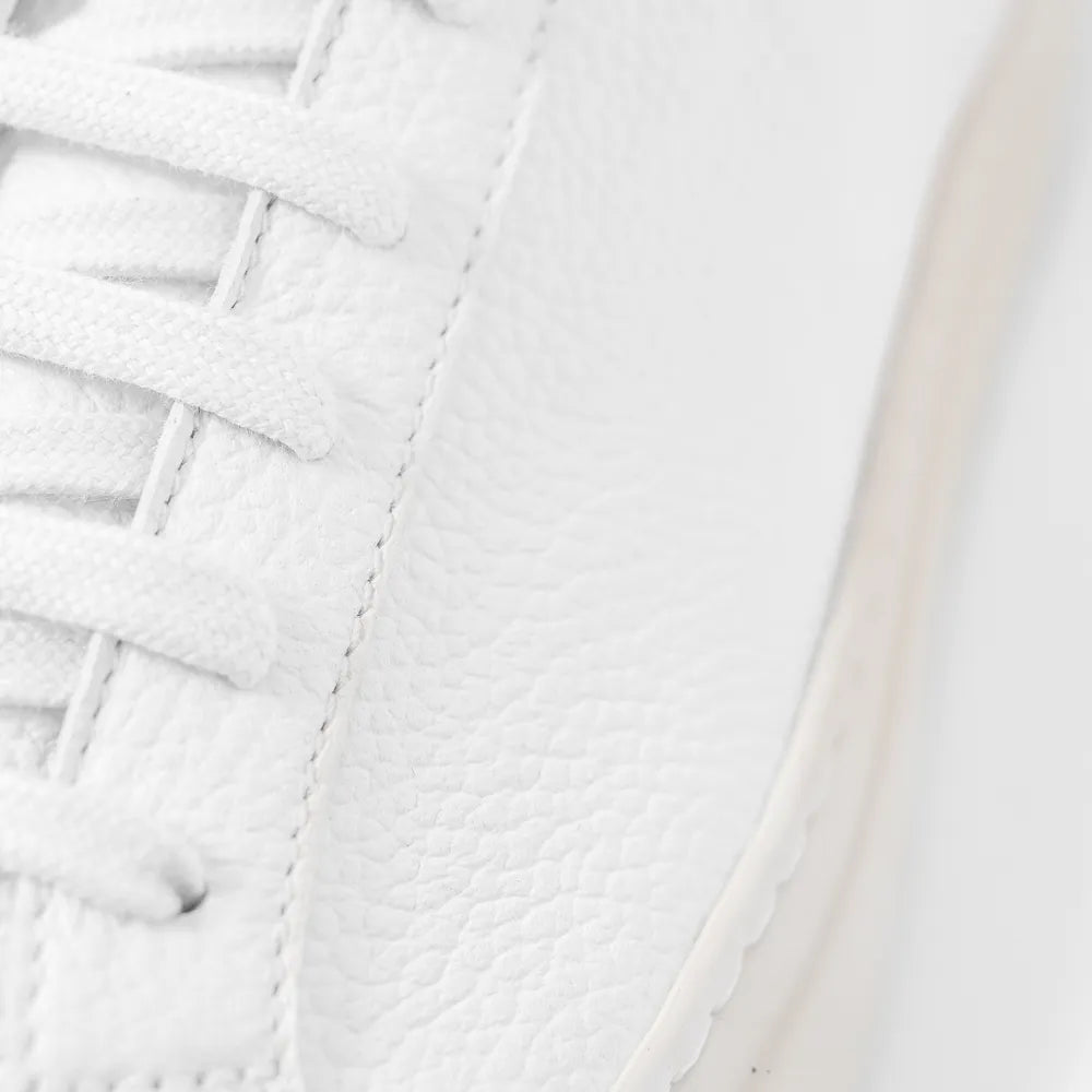Close-up of the tongue and lace construction highlighting textured leather and precise stitching.