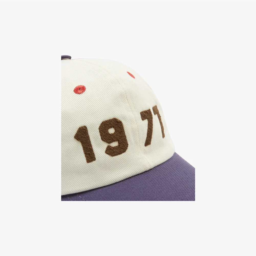 Side view showing the cap’s profile, curved brim, and textured cotton twill fabric.