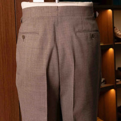 Back view of the Drummers Trousers Beige highlighting the back pockets, seam finishing, and structured drape.