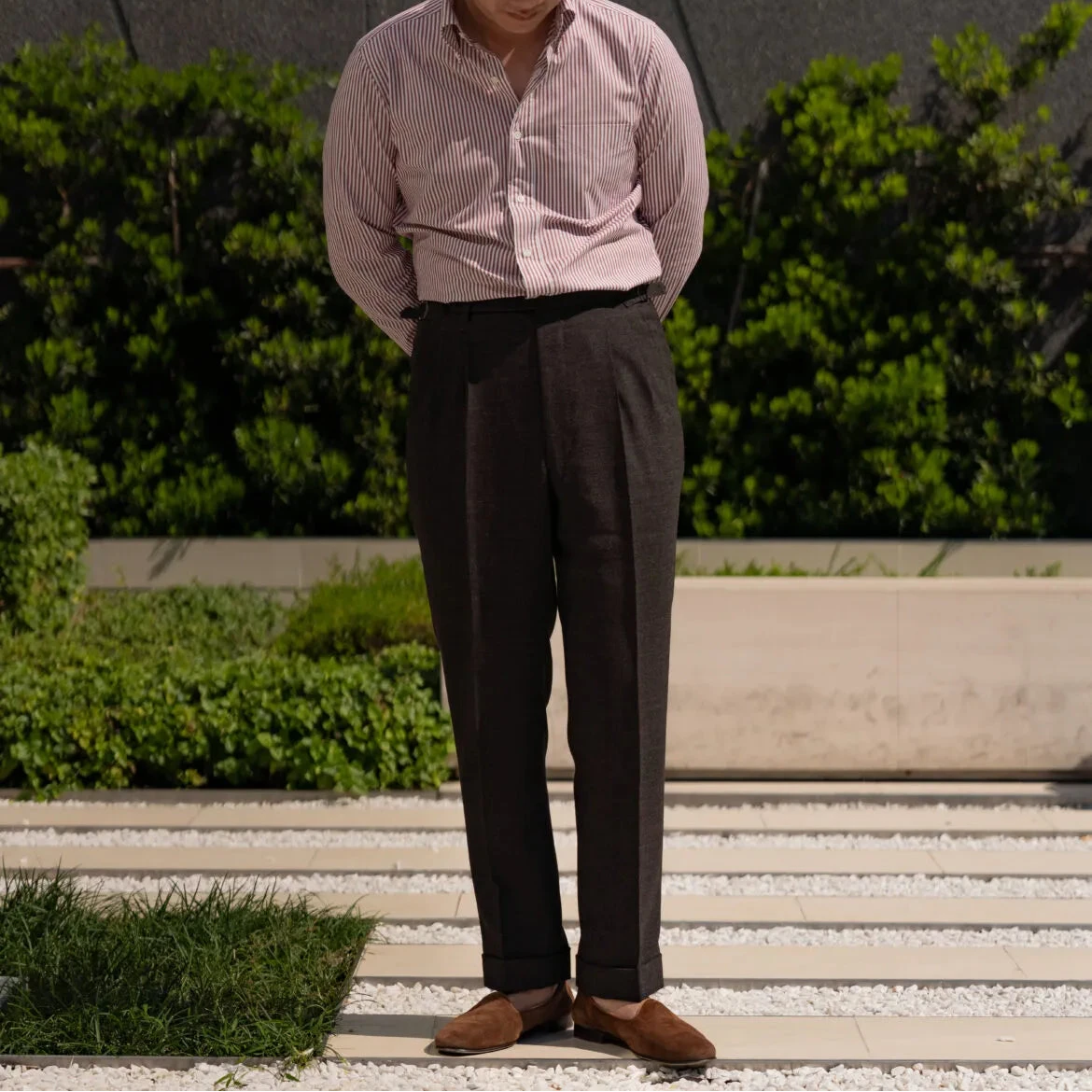 Full body front view of a model wearing the Drummers Trousers Brown showing the straight-leg fit, drape, and natural stance.