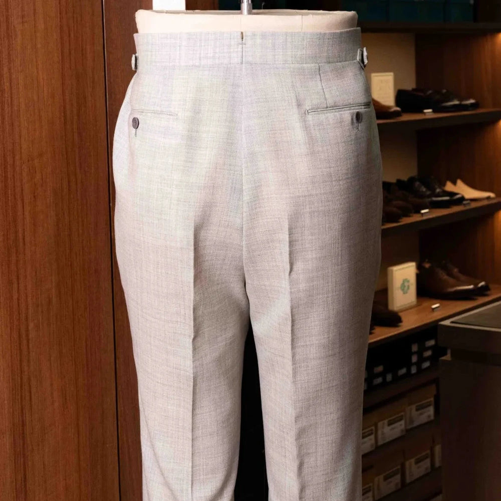 Back view of the Drummers Trousers Light Grey highlighting the back pockets, seam finishing, and structured drape.