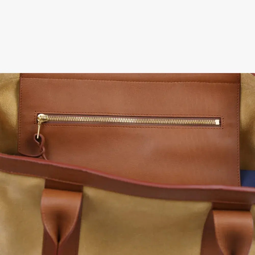Interior zip pocket of the Frank Clegg for Refinement Suede Tote Bag Sand