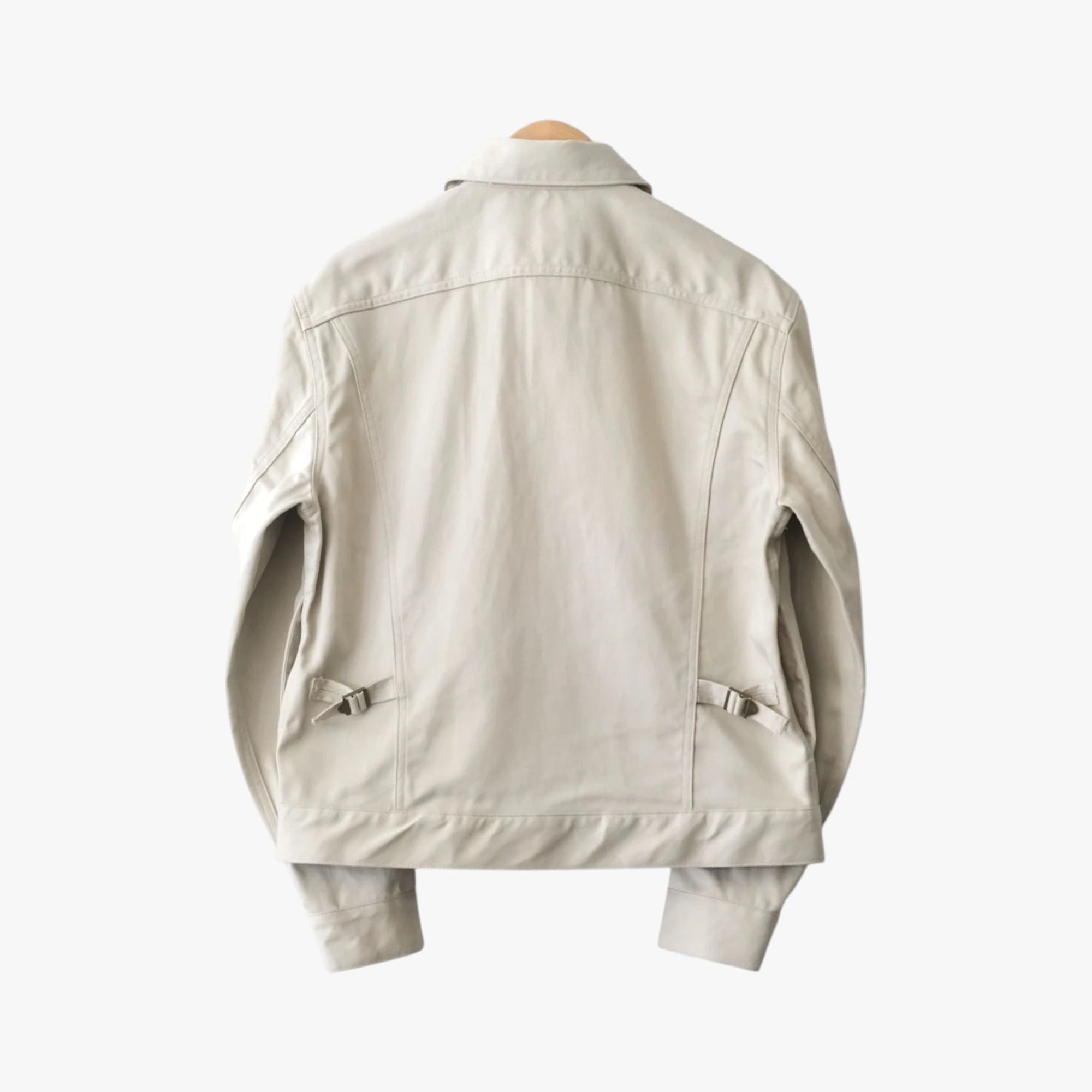 Back view of the Fujito cowboy jacket in light beige showing the structured shape and minimal detailing.