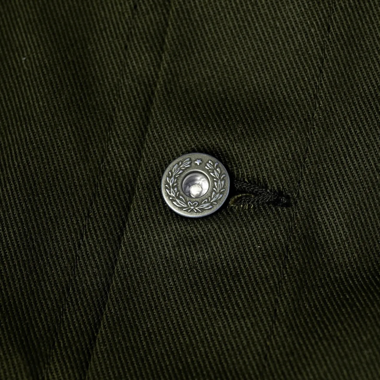 Close-up of the sleeve cuff showing button fastening and clean finishing.
