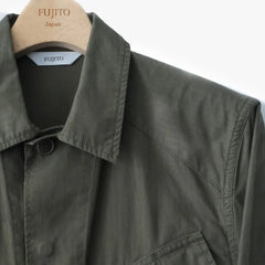 Close-up of the olive green fabric showing texture, weave, and the durable character of the jungle fatigue cloth.
