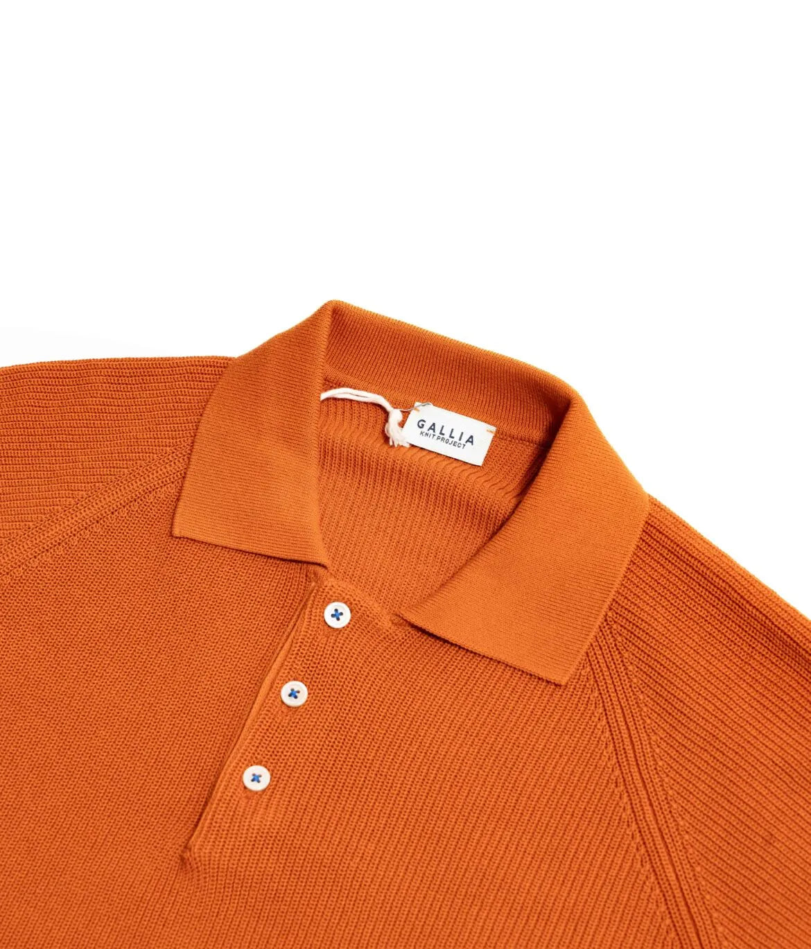 Close-up of the collar of the Gallia Madison Polo in Rust Plain, showing the clean knit structure and refined finish.