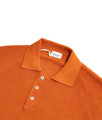 Close-up of the collar of the Gallia Madison Polo in Rust Plain, showing the clean knit structure and refined finish.