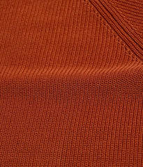 Close-up fabric texture of the Gallia Madison Polo in Rust Plain, showing the knit structure and material quality.