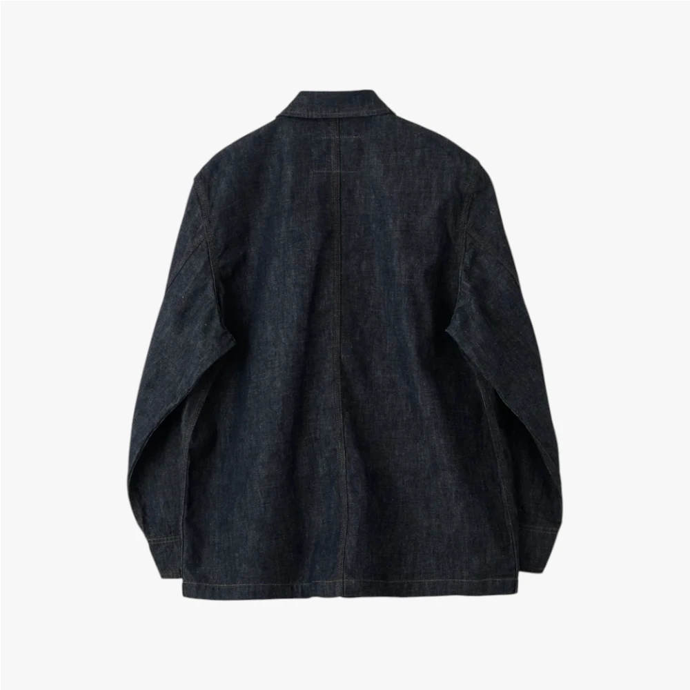 Back view highlighting the clean panel construction, straight hem, and natural drape of the indigo denim.