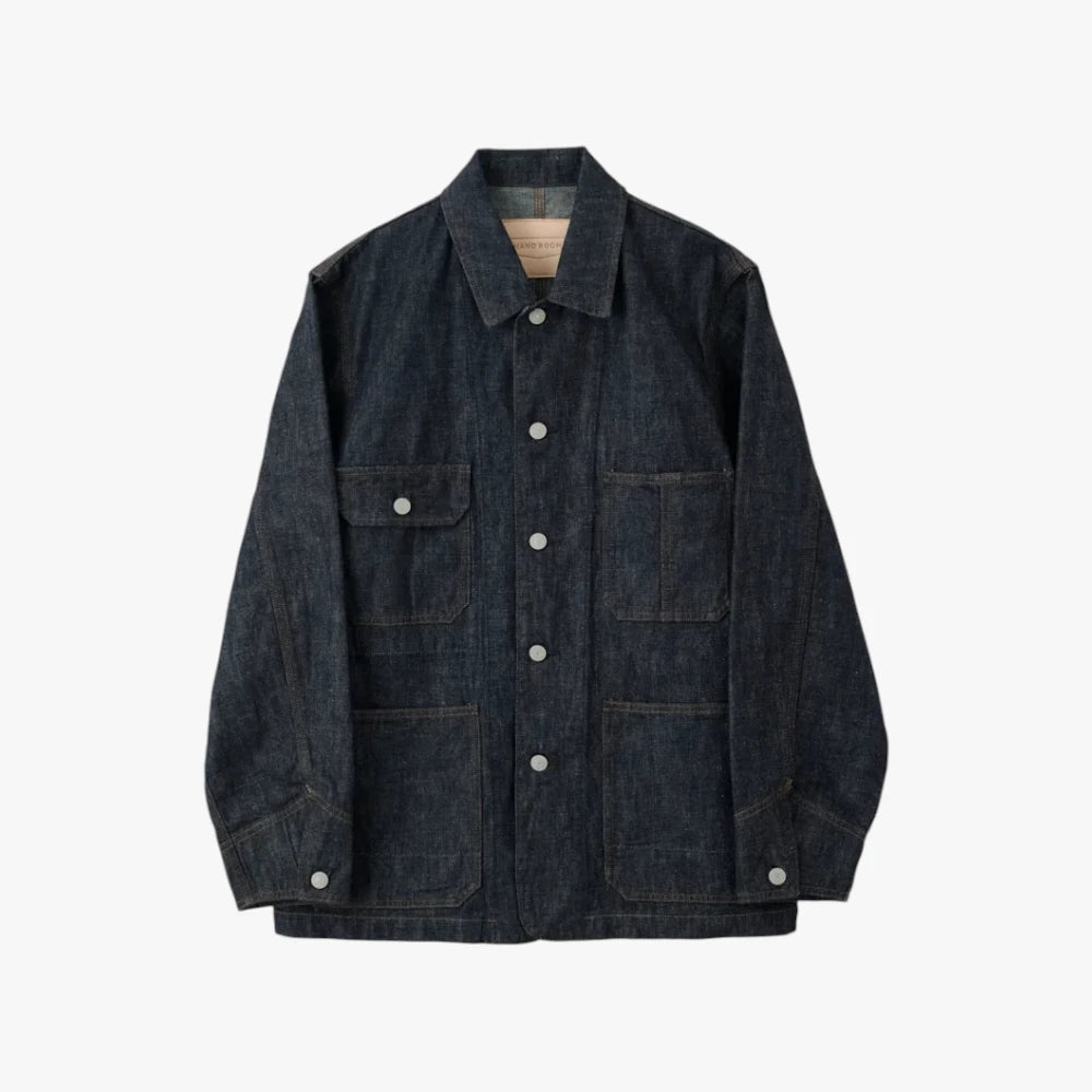 Front view of the Hand Room Denim Coverall Indigo showing the chore jacket silhouette, patch pockets, and mid-weight indigo denim texture.