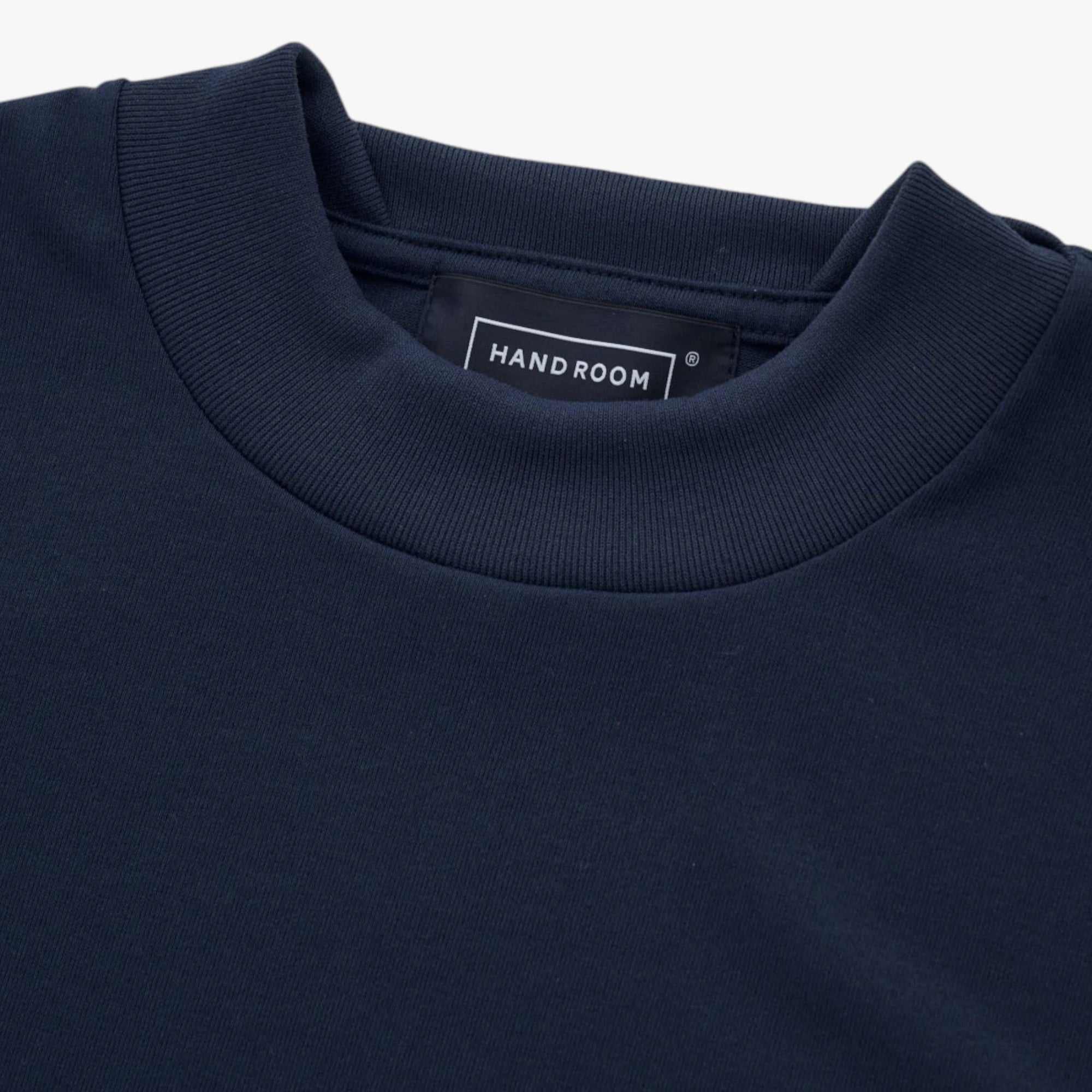 Close-up of the fabric showing soft cotton texture and refined stitching.