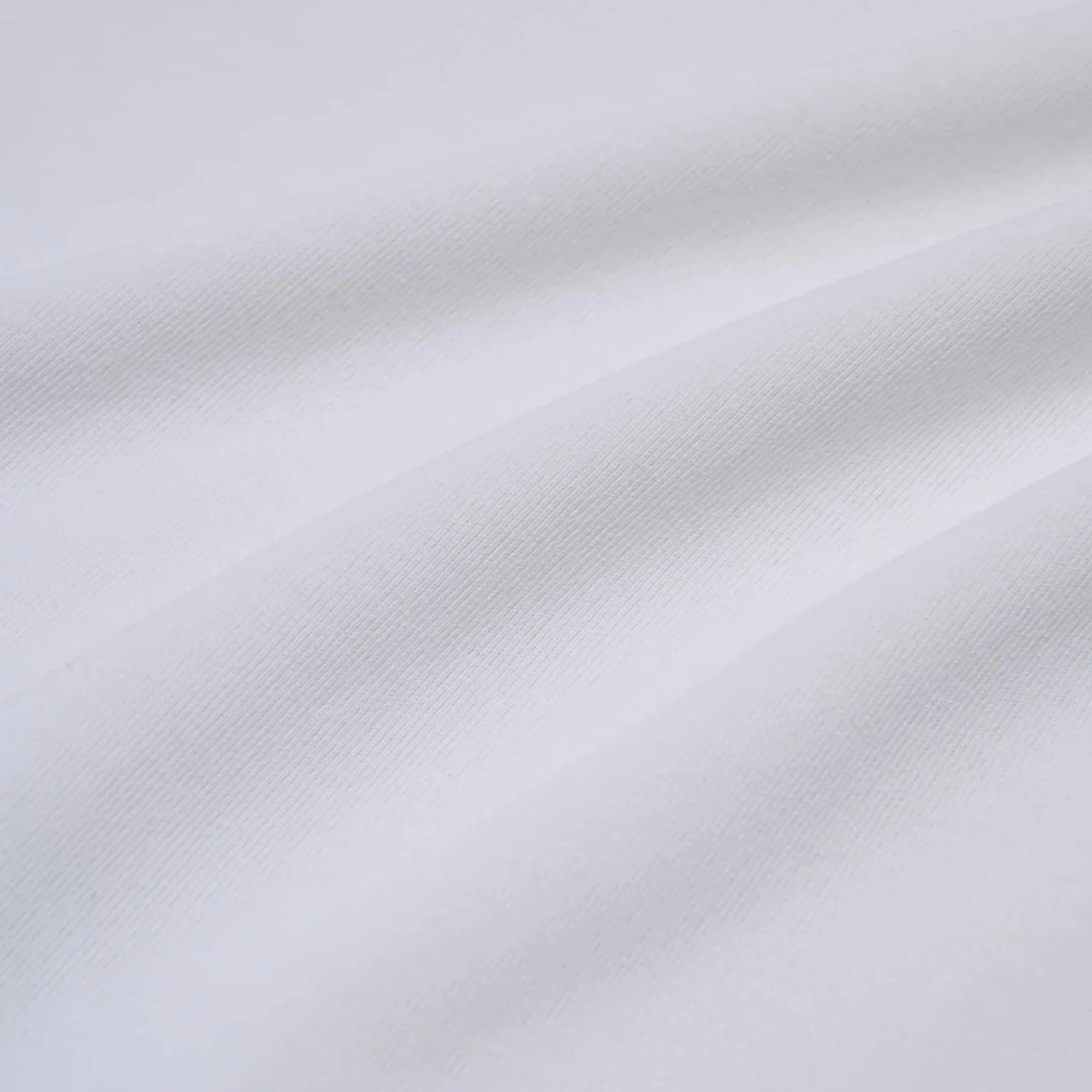 Close-up of the fabric showing soft cotton texture and refined stitching.