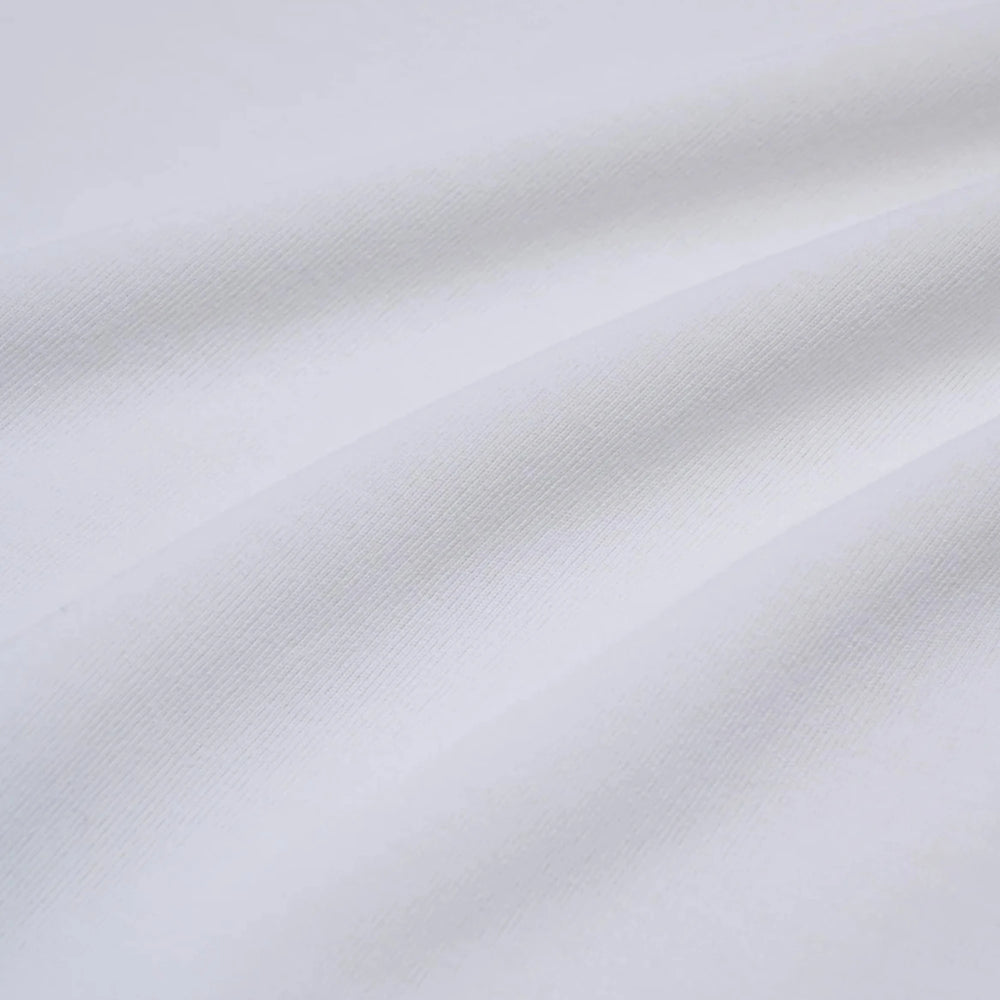 Close-up of the fabric showing soft cotton texture and refined stitching.