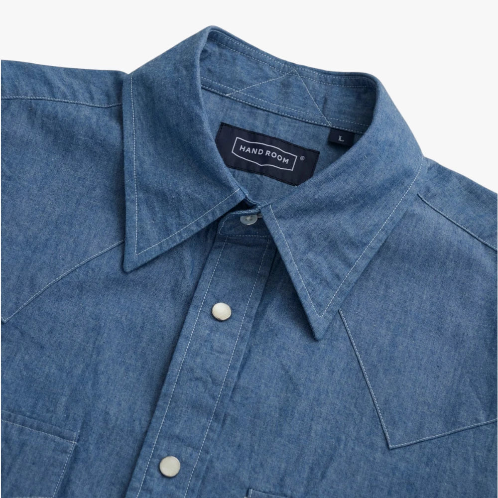 Close-up of the western-style collar showing the clean shaping, stitching accuracy, and chambray weave.