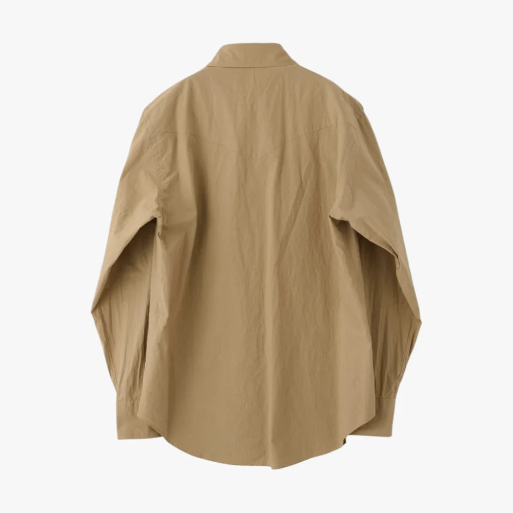 Back view highlighting the western back yoke, clean stitching, and structured drape of the beige typewriter cloth.