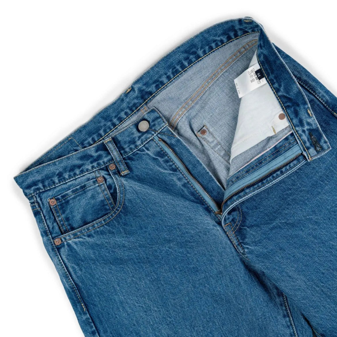 Close-up of the waistband button on the Hand Room Exclusive for Refinement Wide Fit Light Washed jeans