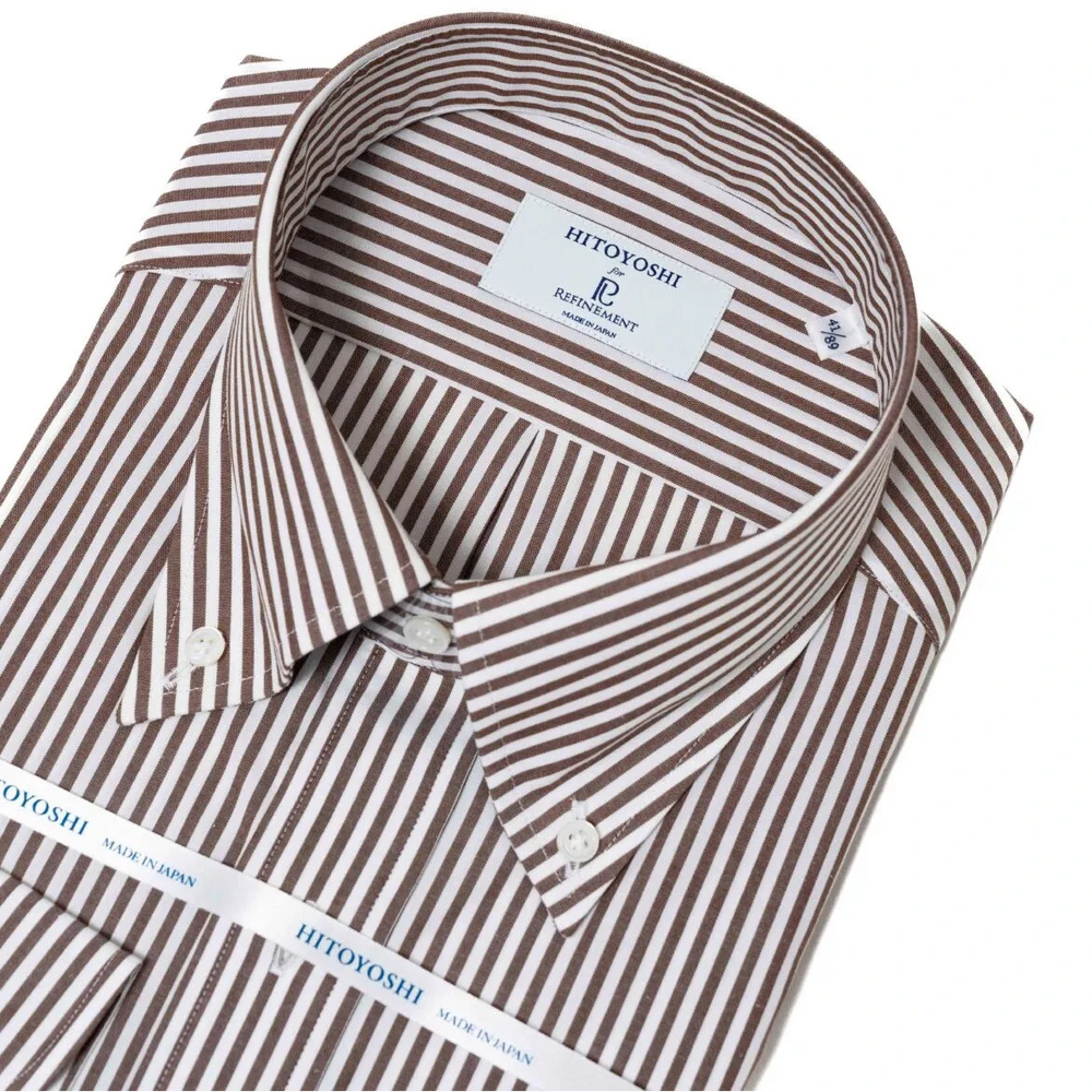 Close-up of the button-down collar showing the roll shape, stitching precision, and red stripe alignment.