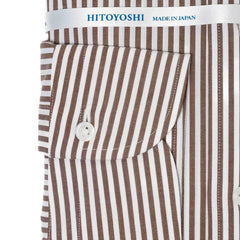 Close-up of the cuff showing button arrangement, stitching, and stripe detailing.