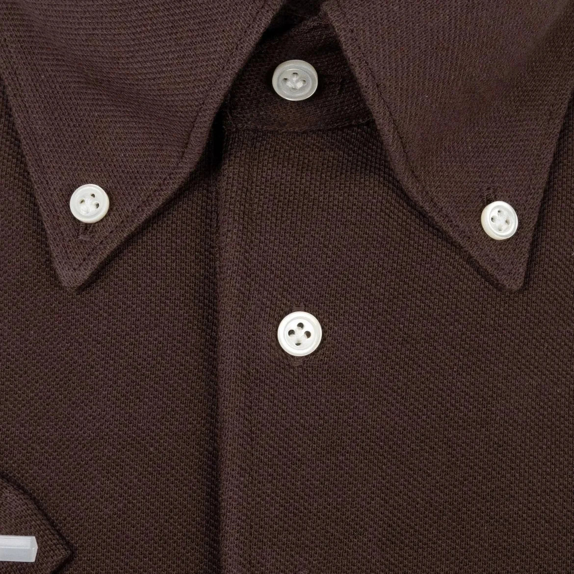 Close-up of the front placket showing button placement, knit density, and clean finishing.