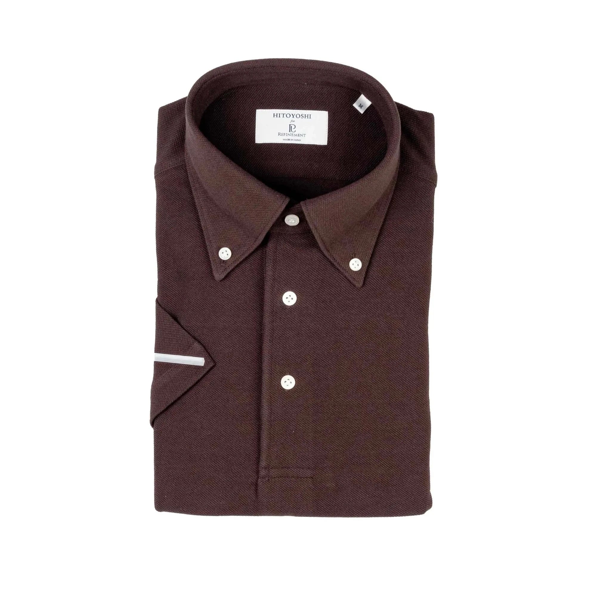 Folded view of the Hitoyoshi for Refinement Button Down Polo Dark Brown showing collar roll, knit texture, and tidy folding.