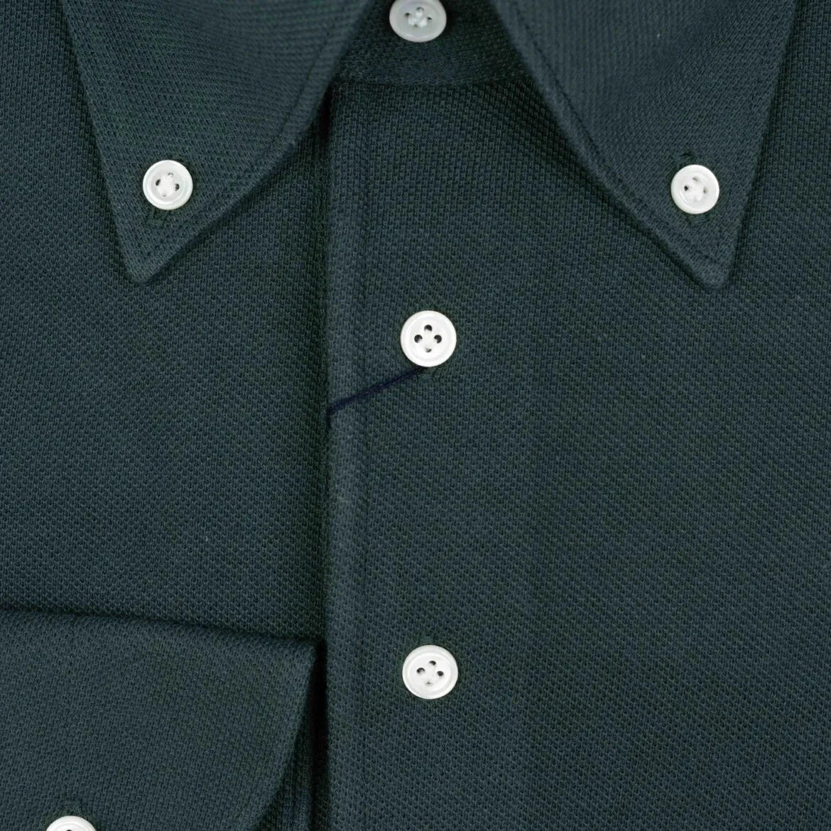 Close-up of the placket showing button layout, knit density, and clean finishing.