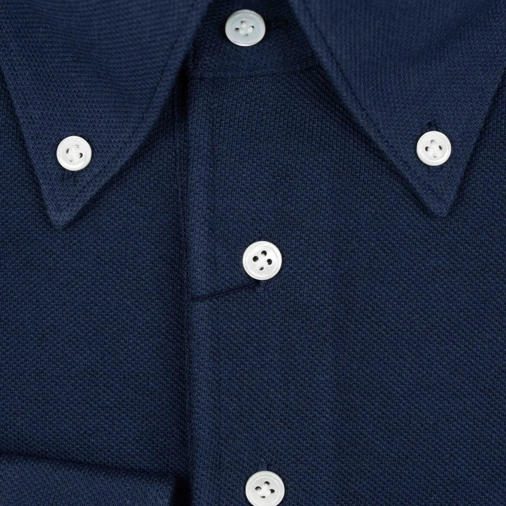 Close-up of the front placket showing button layout, knit density, and clean finishing.
