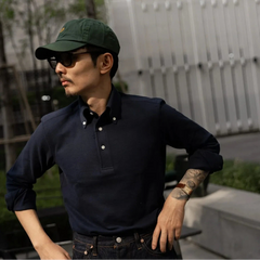 Side view showing sleeve length, shoulder structure, and soft drape of the navy knit fabric.