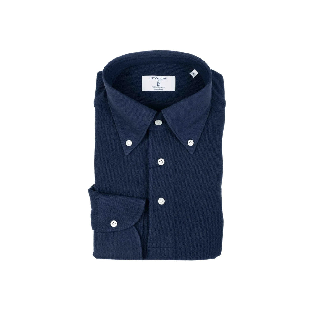Folded view of the Hitoyoshi for Refinement Button Down Polo Long Sleeve Navy showing the collar roll, knit texture, and neat folding.