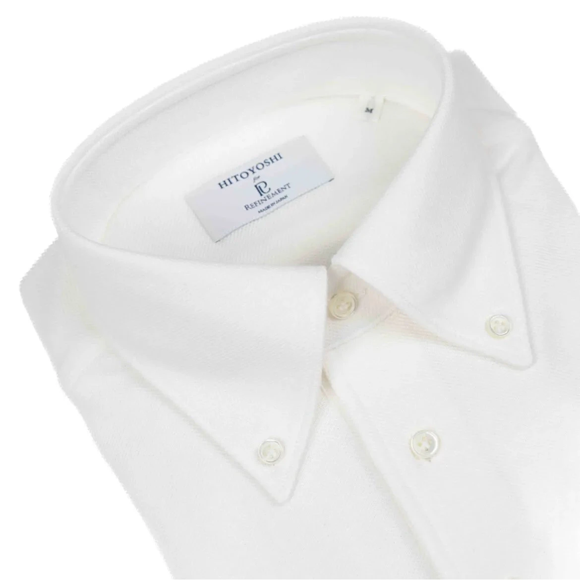 Close-up of the button-down collar showing the roll shape, stitching accuracy, and soft knit texture in off white.