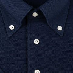 Close-up of the front placket showing button layout, knit structure, and clean finishing.
