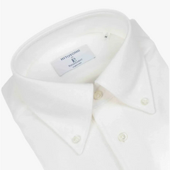 Close-up of the button-down collar showing the collar roll, stitching precision, and knit structure.