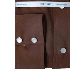 Close-up of the snap buttons showing metallic finish, polished look, and placket detailing.