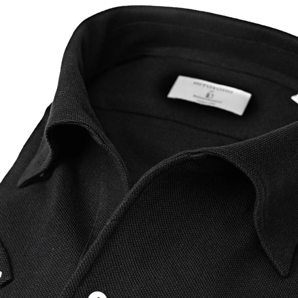 Close-up of the one-piece collar showing its seamless roll, precise shaping, and refined knit texture.