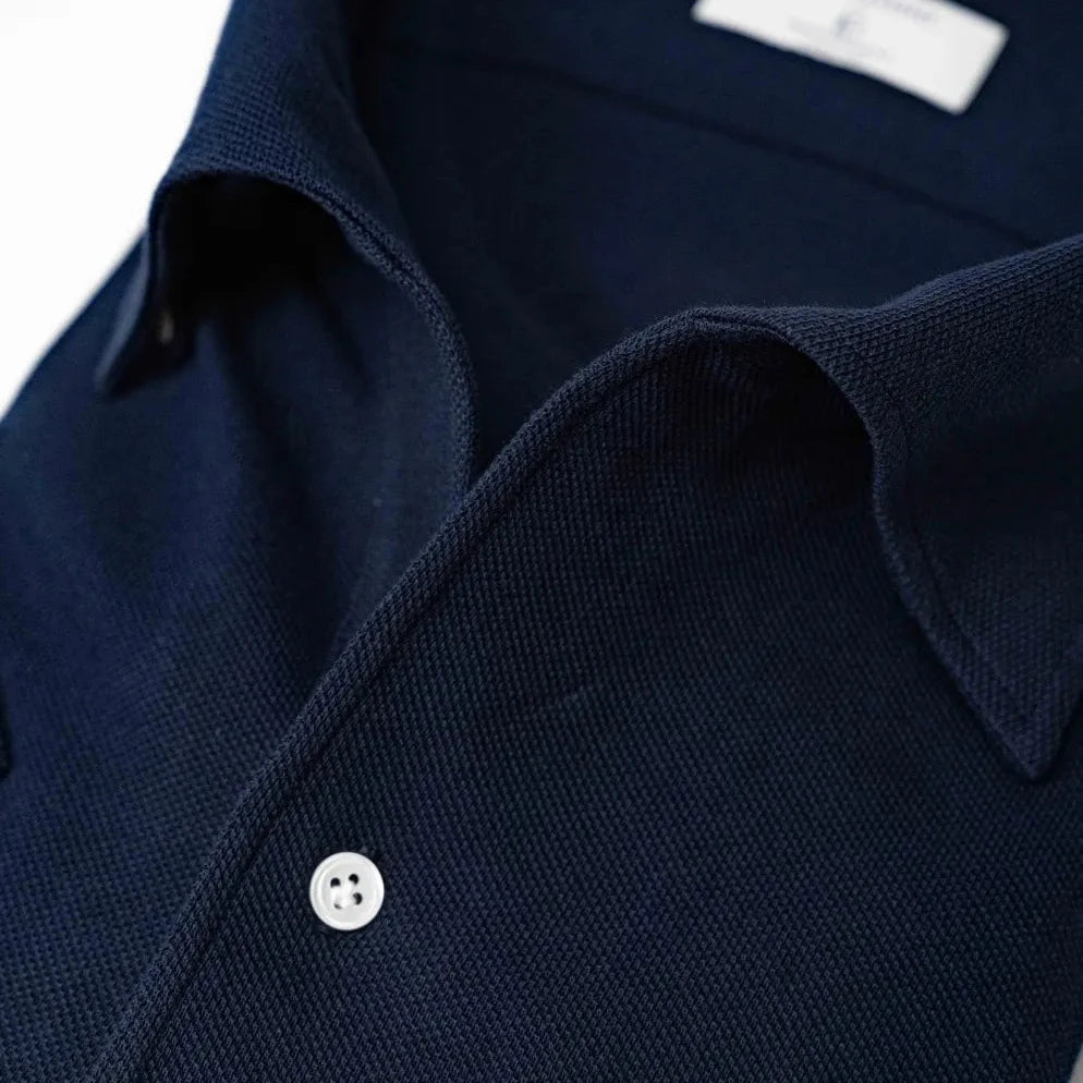 Close-up of the placket showing button arrangement, knit density, and refined finishing.