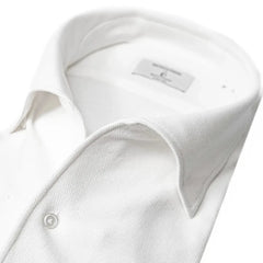 Close-up of the one-piece collar showing its seamless roll, refined shaping, and clean white knit texture.