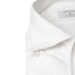 Close-up of the front placket showing button placement, knit density, and precise finishing.
