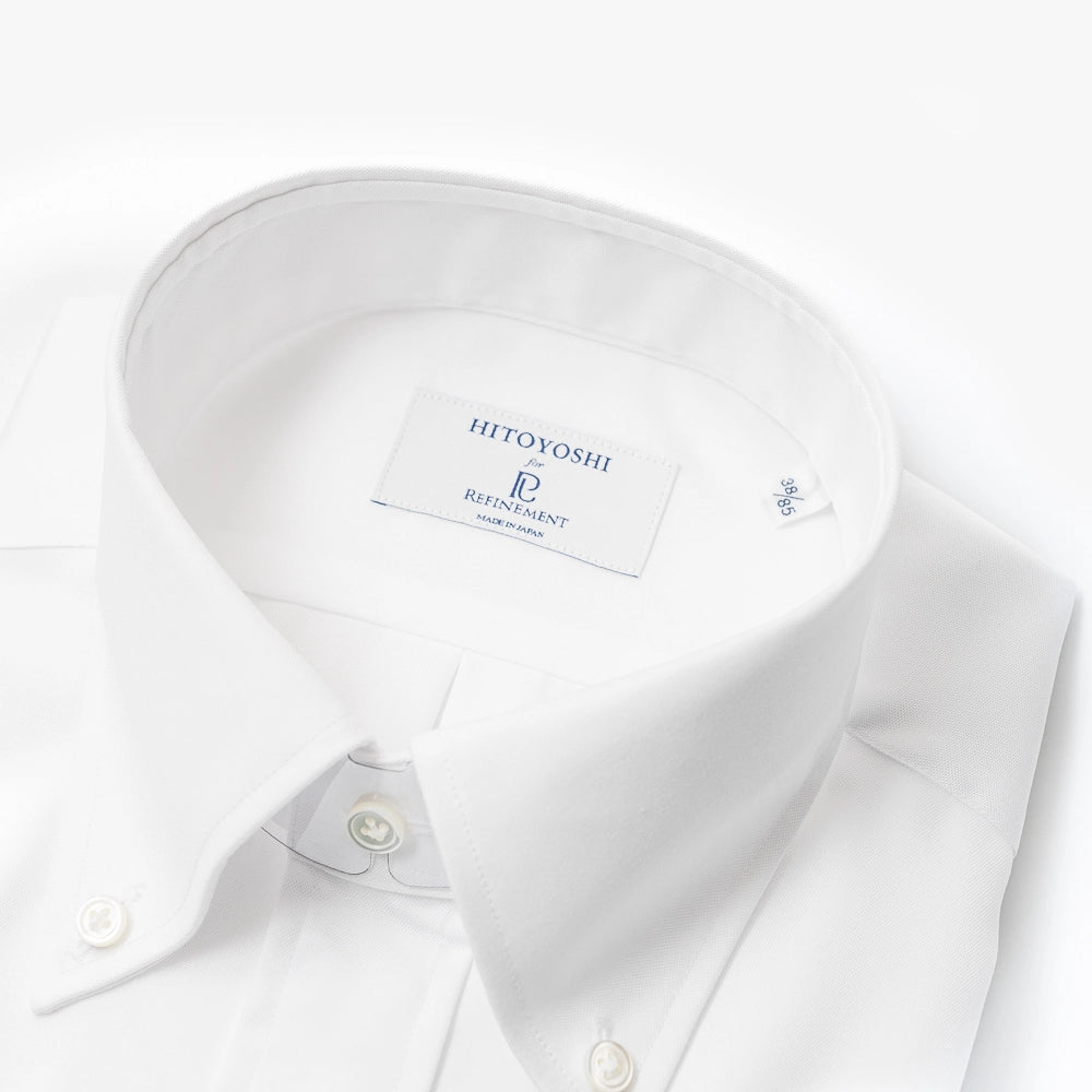 Close-up of the button-down collar showing the roll, stitching precision, and Oxford weave.