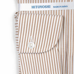 Close-up of the cuff showing stitching, button placement, and stripe continuation.