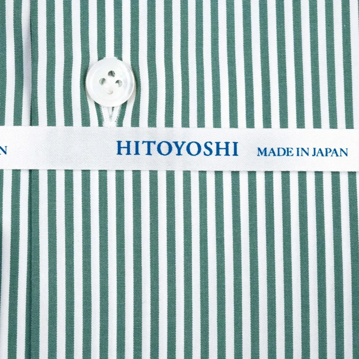 Close-up of the green candy stripe fabric showing smooth broadcloth weave, crisp texture, and vivid stripe pattern.